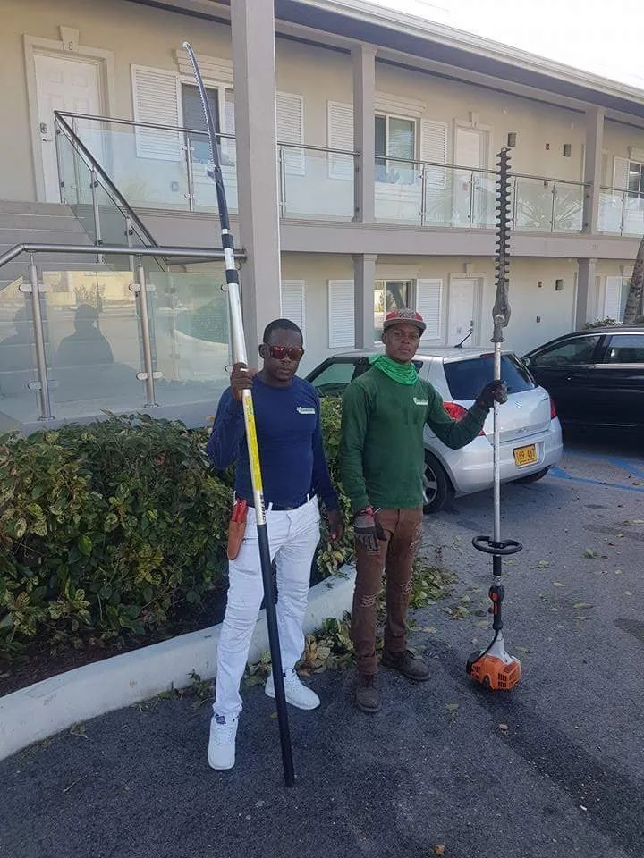 Two Johnson’s Lawn & Garden team members with tools